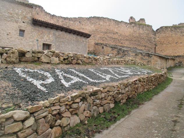 Foto: Nombre de la localidad puesto con piedras - Palazuelos (Guadalajara), España